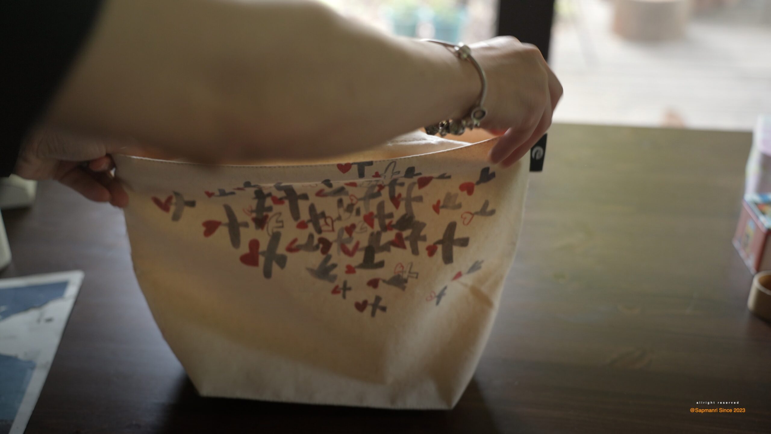 The original canvas tote held open so its handle attachment can be checked.