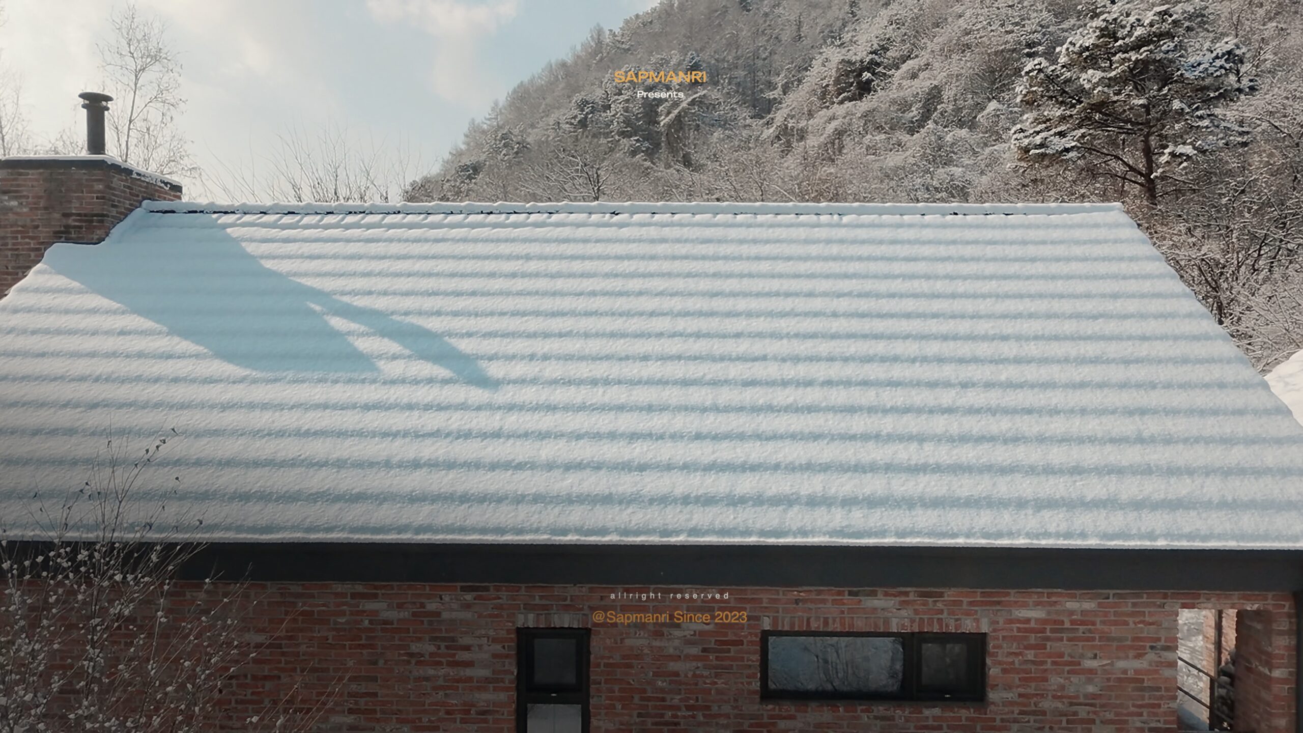 A close view of a low roof covered by a thick, undisturbed layer of snow.
