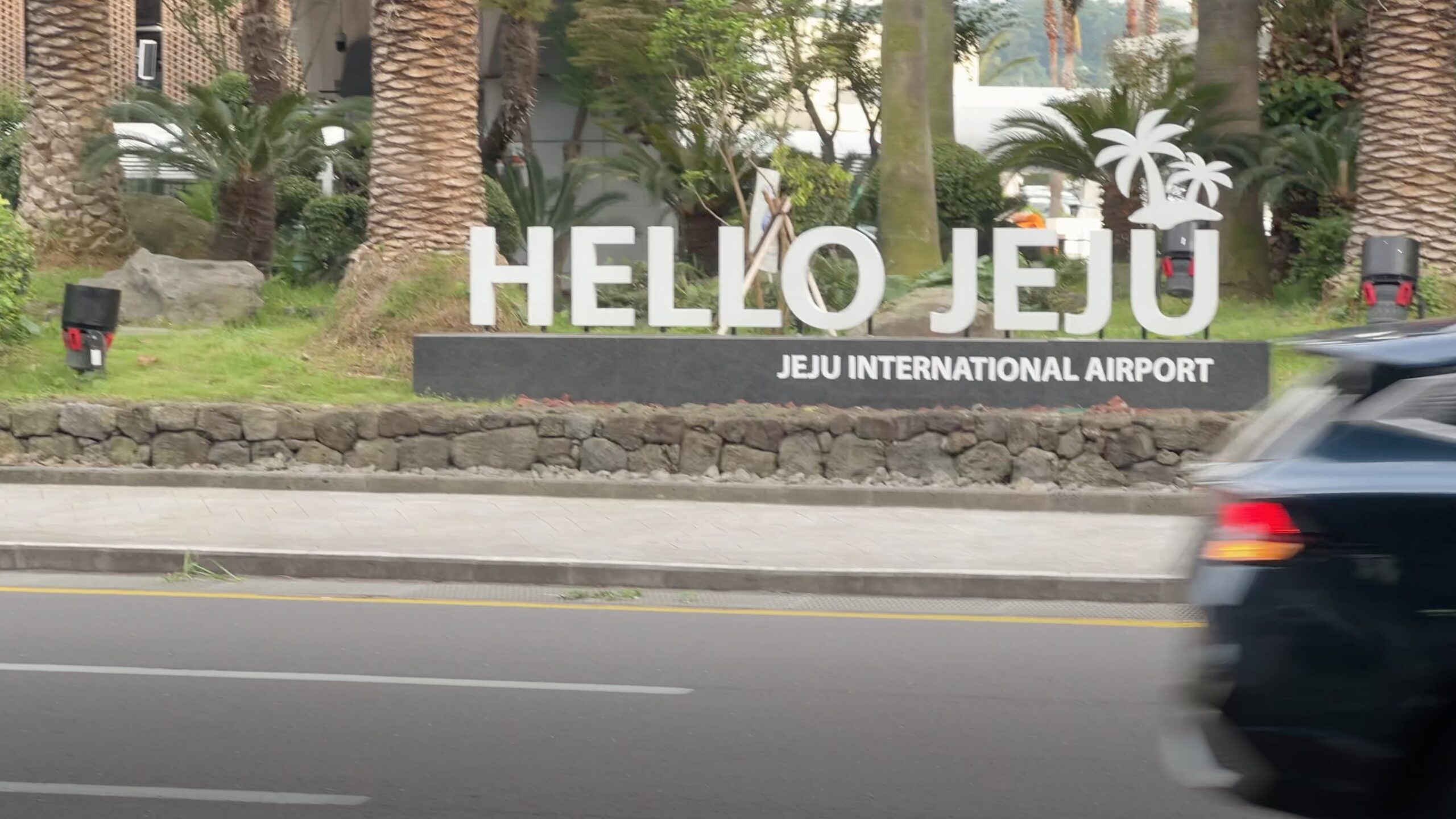 The Hello Jeju sign outside Jeju International Airport seen from the road.